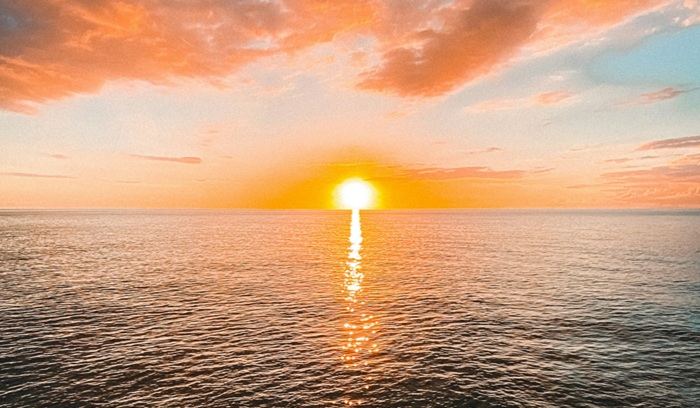Sun rising on the ocean, from article "Is the world getting better or worse?"