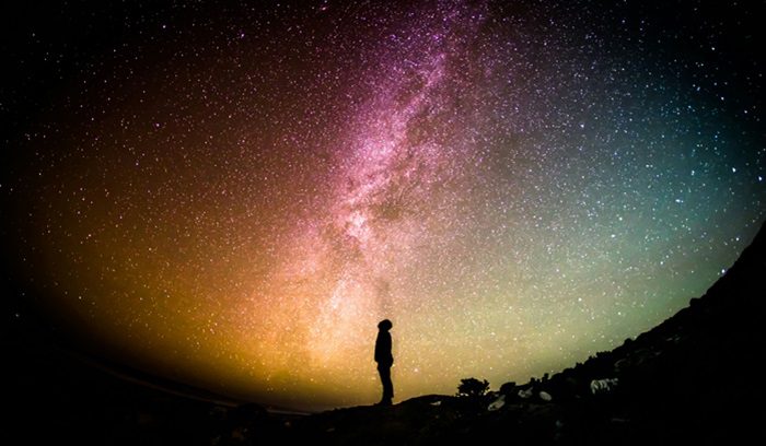 Silhouette of human looking up at the stars