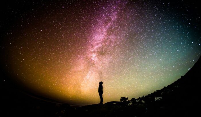 A man staring up at the stars (representing the peace of the thriving life)