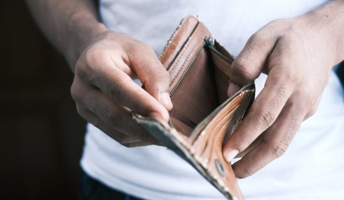 A man hand open an empty wallet, for article on world poverty rate