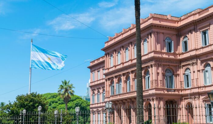 Argentinian flag flying near a building, for article on crimes against trans women