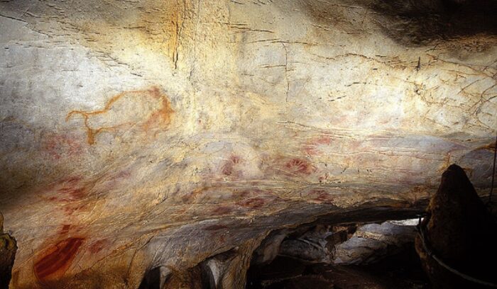 Ancient painted hand stencils on a cave wall for an article about Spanish cave art