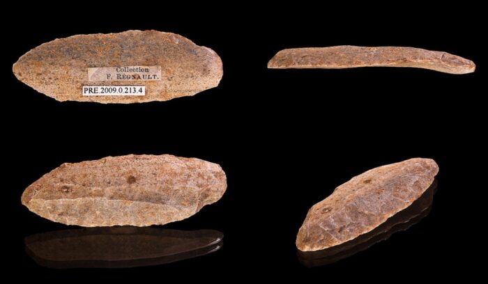 Shaped stone spear points resting on rock surface for an article about stone-tipped spears