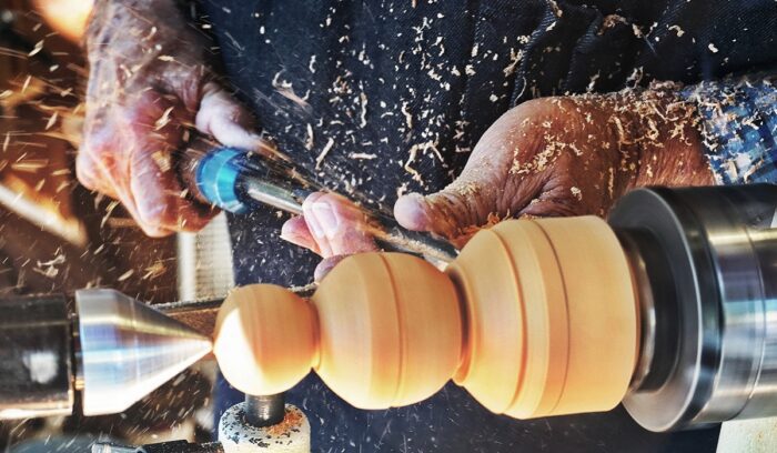 Hands working a lathe, for article on lathe history