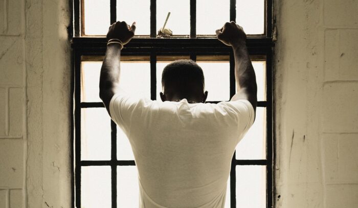 Empty prison corridor with open cell doors for an article about global prison population