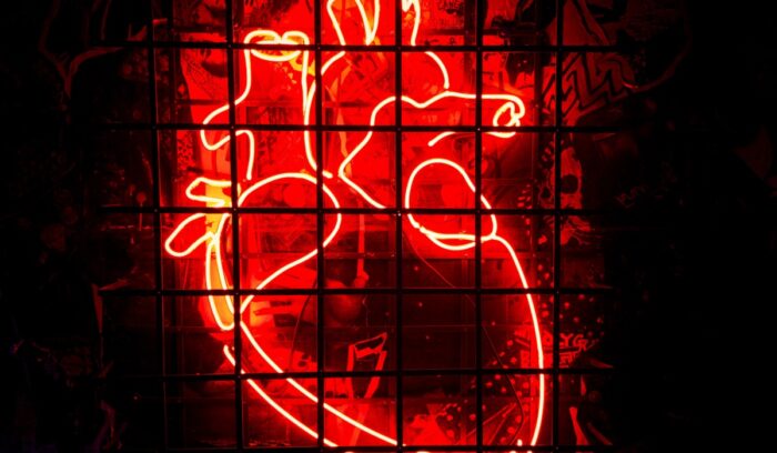 Neon light of realistic heart, representing the act of opening your heart to save the world