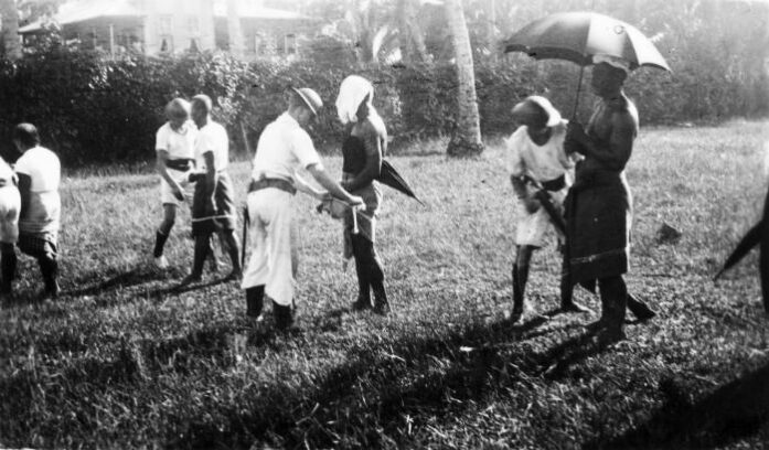 New Zealand sailors removing white band insignia of the Mau 1930, for article on Helen Clark apology Samoa