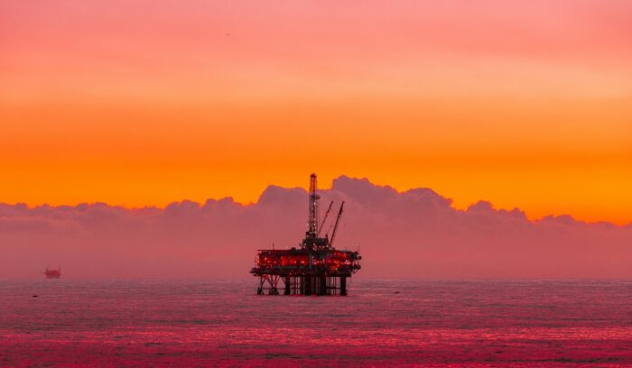 Offshore oil rig at sunset, for article on offshore drilling ban