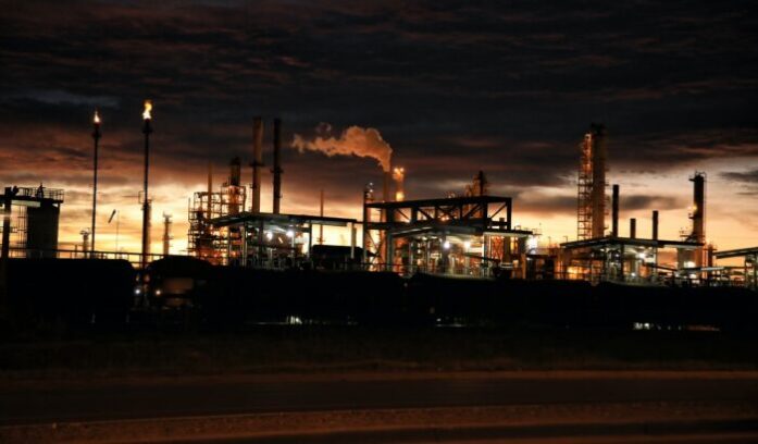 Oil refinery representing fossil fuel divestment debate and the push to move away from petroleum infrastructure
