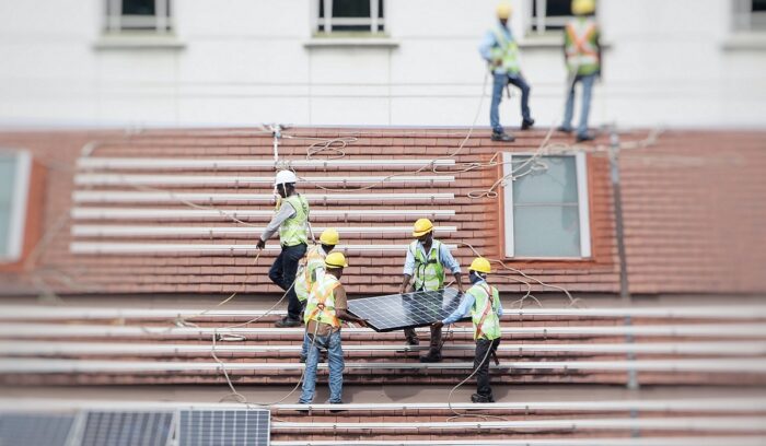 People installing solar panels for Florida solar property tax exempt home energy upgrade