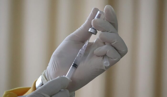 Person filling syringe with vaccine, for article on mpox vaccines for Africa