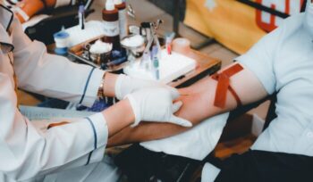 Person giving blood, for article on blood donation ban