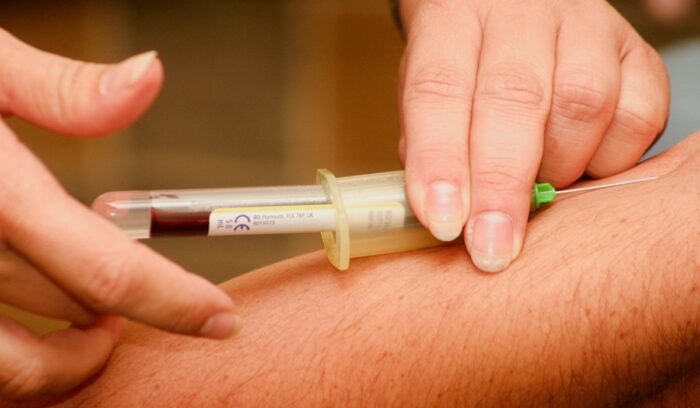 Person having blood drawn, for article on Alzheimer's blood test