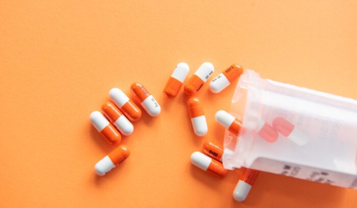 Pills spilling out of pill bottle, for article on march-in rights policy