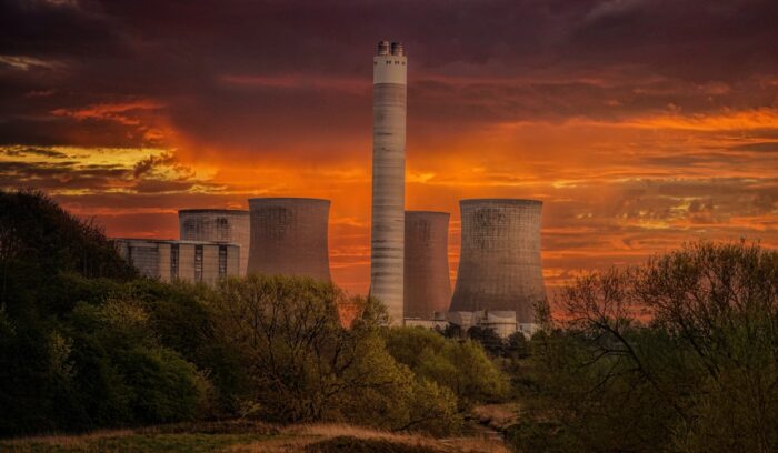 Power plant with orange sky in background|dominik vanyi unsplash