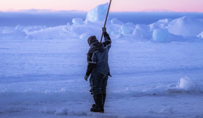 Sea ice fisherman checking the sea ice if it is safe, for article on Thule people Inuit