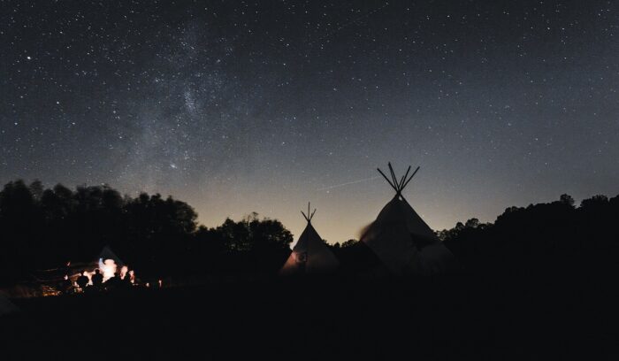 Tepees and fire at night, for article on sweat lodge traditions