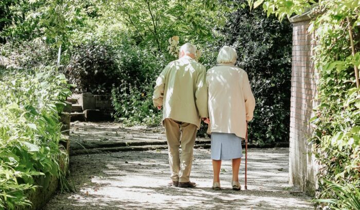 Two elderly people walking, for article on global life expectancy