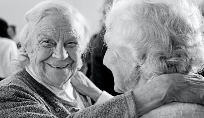 Two elderly women embracing