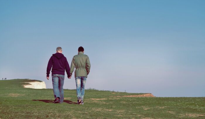 Two men walking by a cliffside, for article on same-sex marriage popular vote