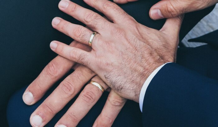Two men's hands with rings on them, for article on Switzerland same-sex marriage