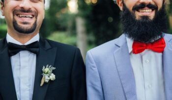 Two people holding hands at a courthouse steps for an article about same-sex marriage legalization