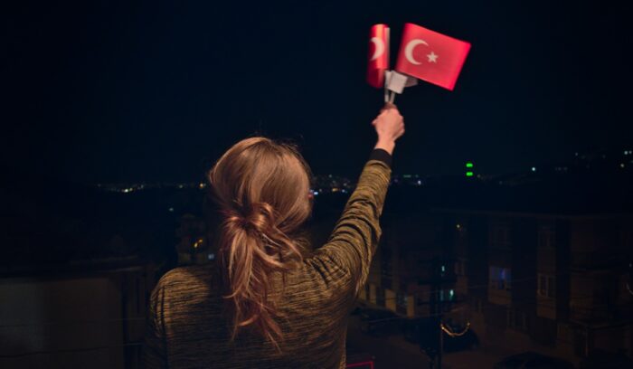 Woman holding Turkish flags