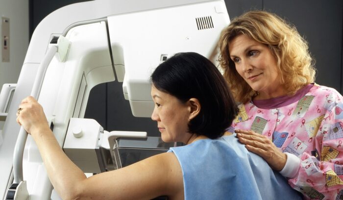 Woman receiving mammogram, for article on U.K. cancer mortality drop