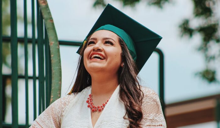 Woman with graduation cap smiling