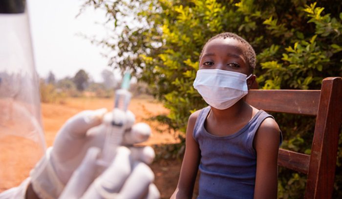 A doctor is about to vaccinate a child, for article on malaria vaccine rollout