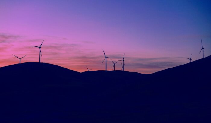 Silhouette of wind turbines at dusk