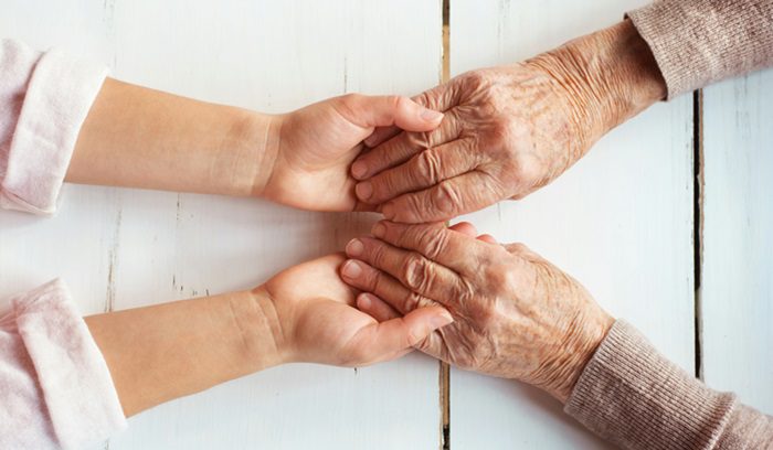 Two people holding hands, for article on Parkinson's infusion device, for article on Onapgo approval