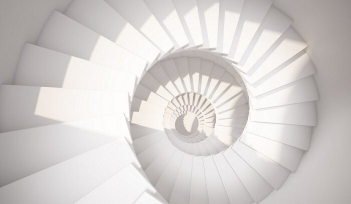 White spiral staircase from above, representing emergence from article: What is change