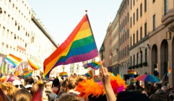 Pride celebration with pride flag in foreground