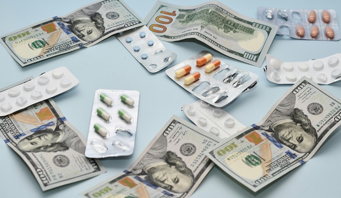 Dollar bills and pills, representing medical debt