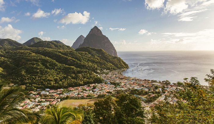 Rainbow flags flying against a blue sky, for an article about Saint Lucia decriminalization of same-sex conduct