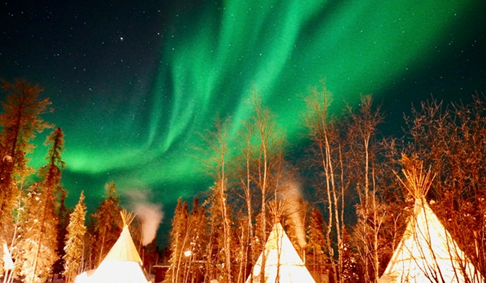 Northern lights over teepees