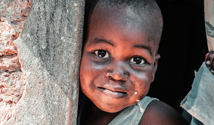A child attending a rural school classroom for an article about extreme child poverty
