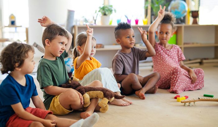 Young children playing together at a child care center for an article about New Mexico universal child care
