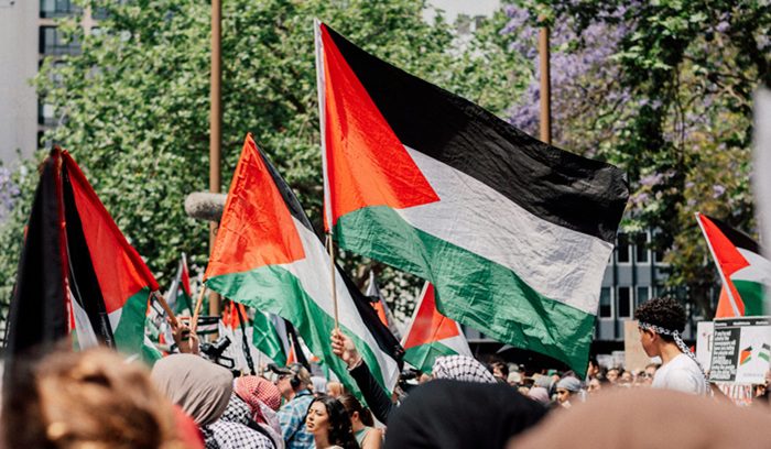 Palestinian flags raised outside a government building for an article about Palestinian state recognition