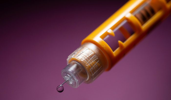 A person holding an insulin pen for an article about California low-cost insulin program