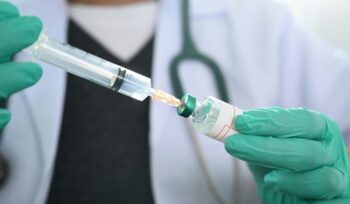 Syringe extracting from a vaccine vial