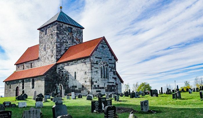 Exterior of a traditional Norwegian wooden church in winter for an article about the Church of Norway apology to LGBTQ+ members