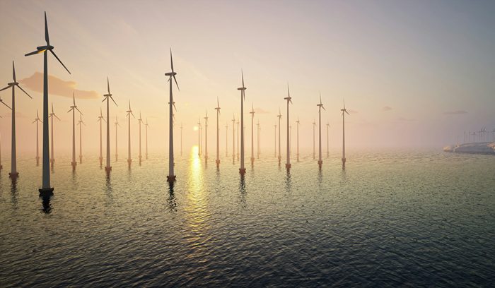 Offshore wind turbines rising from the North Sea at dusk for an article about the North Sea wind hub