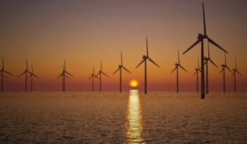 Offshore wind turbines at sunset