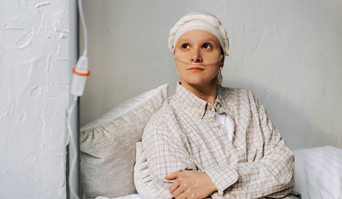 A doctor reviewing patient records in a bright clinic for an article about U.S. cancer survival rates