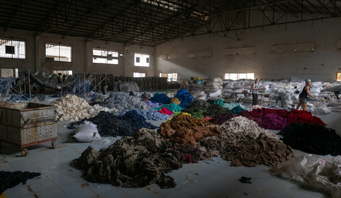 Abandoned factory full of colorful textiles