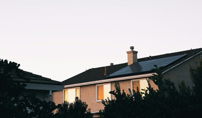 Rooftop solar panels on a row of newly built houses for an article about solar panels on new buildings