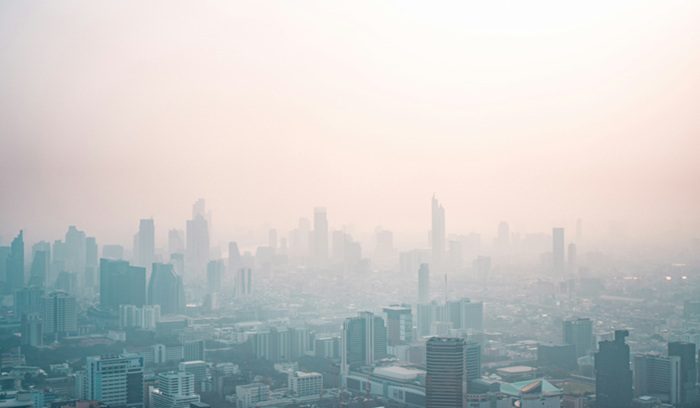 Cyclists and pedestrians on a car-free urban street for an article about urban air pollution cuts
