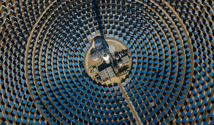 Solar panels and wind turbines generating clean electricity for an article about renewable energy capacity